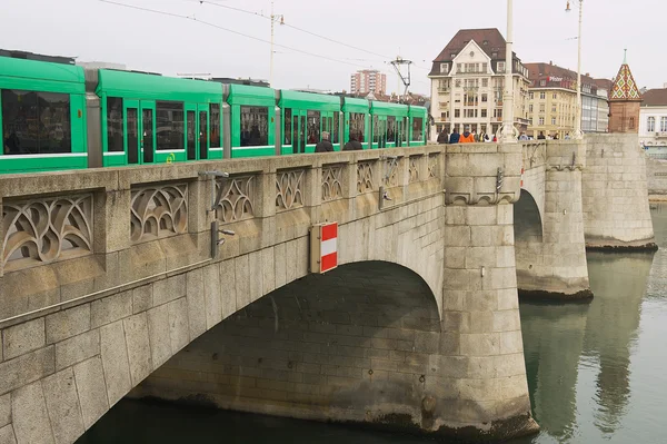 Tram passes by the bridge over Rhine river in Basel, Switzerland. — Stock Fotó