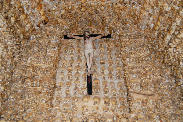 Human skulls and bones fixed in the wall of the Chapel of Bones (Capella dos Ossos) at Alcantarilha in Silves, Portugal.