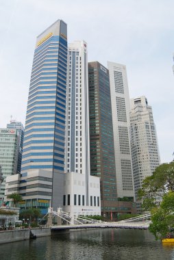 View to the modern buildings and the old Cavenagh bridge in Singapore, Singapore.