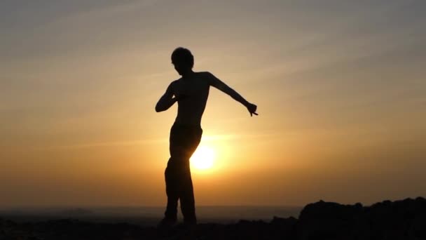 Танец человека на закате . — стоковое видео