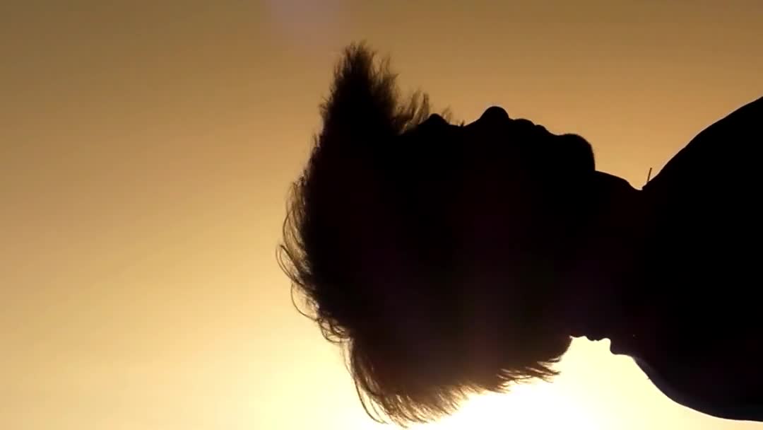 The Man Shakes His Head at Sunset. Slow Motion. — Stock Video