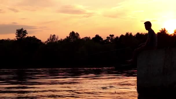 Nelayan Duduk di Dermaga dan Memancing. Matahari terbenam . — Stok Video