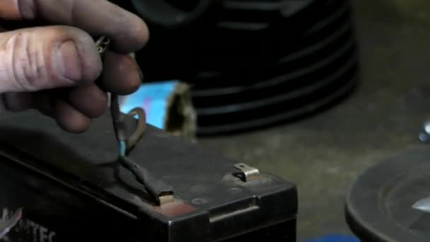 Hand een klein lampje verbinden met de batterij. — Stockvideo