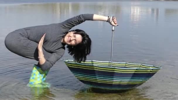 Girl Standing in the Water and Twirls the Umbrella in Slow Motion. — Stock Video