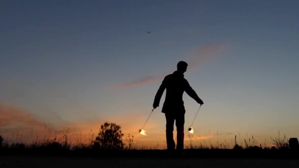 Fire Show at Sunset. Man Used Poi to Making Beautiful Effects. Slow Motion. — Stock Video