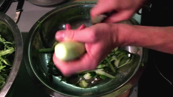 Hands clean cucumber special knife. — Stock Video