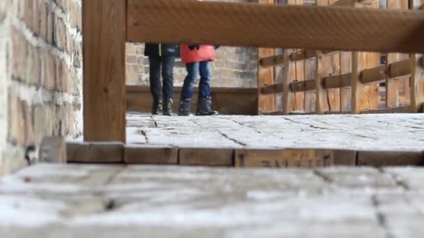 Ein junges Mädchen spielt Verstecken auf der Treppe des alten Schlosses. — Stockvideo