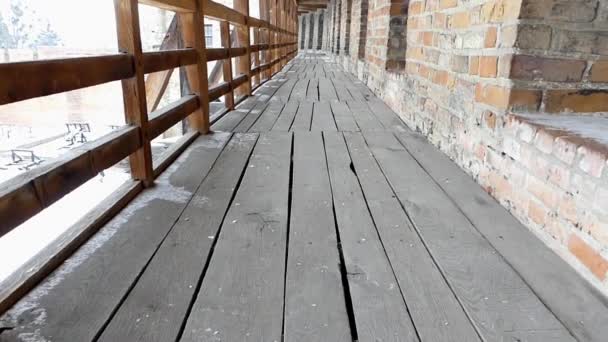 Long hallway in ancient castle. Wooden boards and bricks. — Stock Video