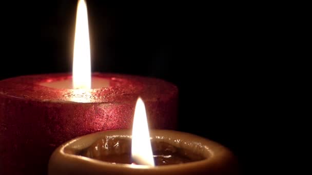 Two candles in dark room. One red another yellow. — Stock Video