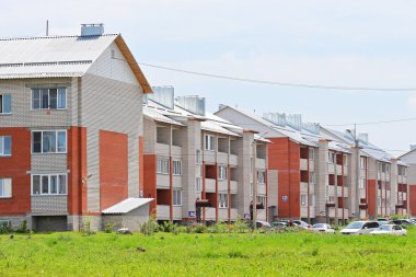 New three-storey brick apartment houses clipart