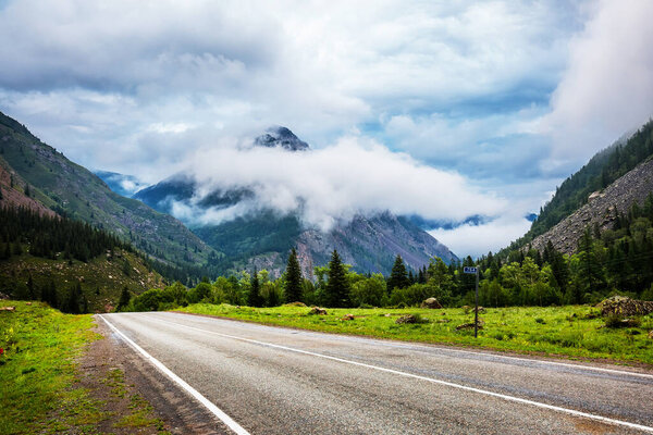 Chuysky tract in the early morning, a road with fog in the intermountain valley. Ongudaysky district of Gorny Altai, Russia