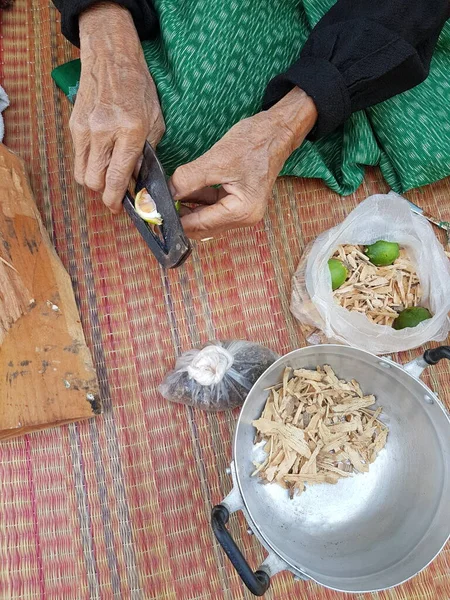 Old people cooking betel nut To chew in free time.