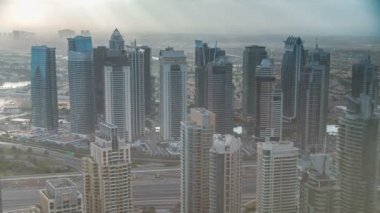 Morning in Dubai Marina with towers and traffic on road from skyscrapper, Dubai, UAE timelapse 4K