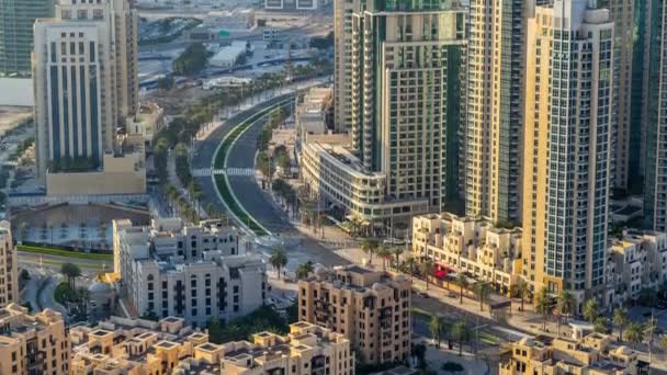 Top view of road in Dubai downtown timelapse with day traffic and illuminated skyscrapers. — ストック動画