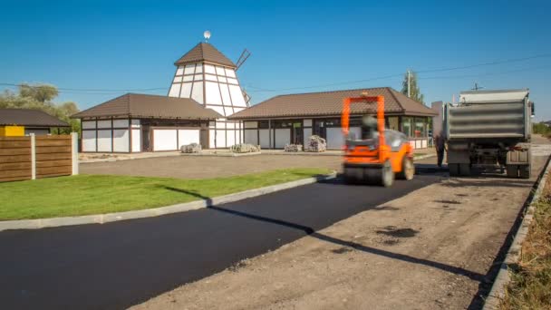 Workers operating asphalt paver machine during road construction and repairing works timelapse — Stock Video