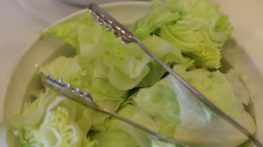 Beyaz bir masada taze yeşil salata Kase