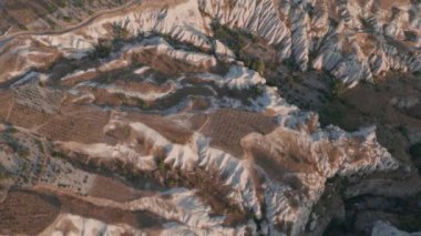 Güneş doğarken, Kapadokya 'nın peri masalı tepelerinde sabah güneşiyle birlikte sıcak hava balonundan hava manzarası..