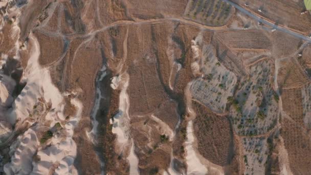 Aerial view from hot air balloon during Sunrise over the fairytale landscape hills of Kapadokya with morning light. — Stock Video