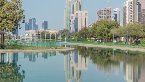Corniche boulevard beach park along the coastline in Abu Dhabi timelapse with skyscrapers on background. — Stock Video