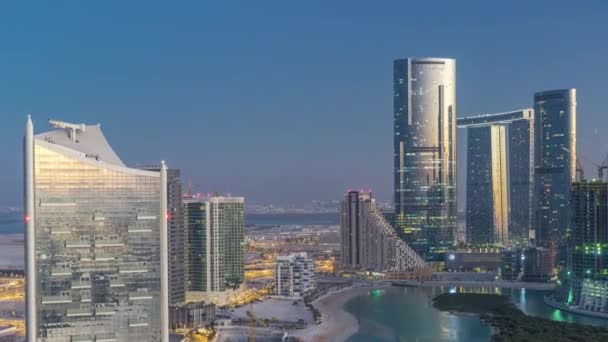 Buildings on Al Reem island in Abu Dhabi day to night timelapse from above. — Stock Video