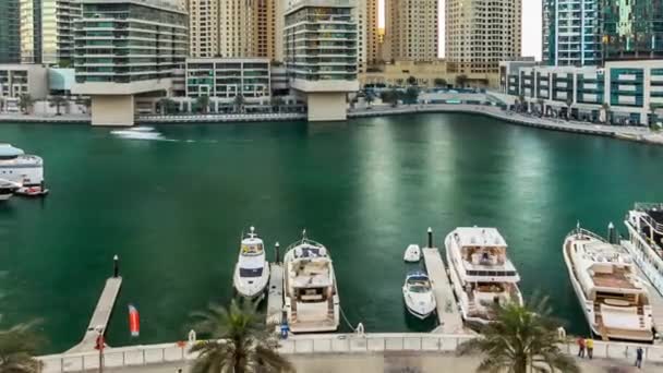 Dubai marina with modern buildings and traditional boat timelapse — Stock Video