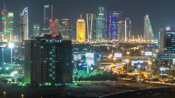 Dubai downtown skyline timelapse at night. Rooftop view of Sheikh Zayed road with numerous illuminated towers. — Stock Video