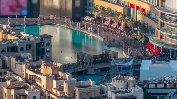 Overzicht met dansende fonteinen in het centrum en in een door de mens gemaakt meer met brug timelapse in Dubai, Verenigde Arabische Emiraten. — Stockvideo