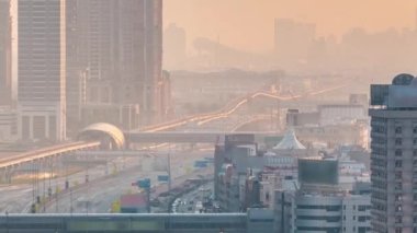 Akşam saatlerinde Dubai Kuleleri 'nin aşağısında. Gün batımında gökdelenli Şeyh Zayed yolunun hava görüntüsü..