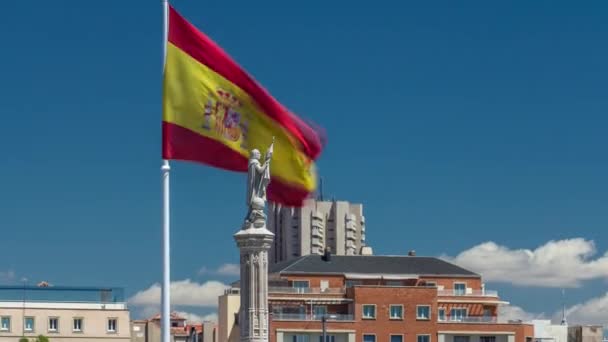 Spanyol zászló hullámok mögött szobor Christopher Columbus timelapse, plaza de Colon Madridban, Spanyolország