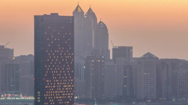 Buildings on Al Reem island in Abu Dhabi day to night timelapse from above. — Stock Video