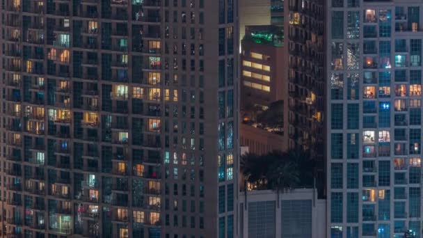Windows in high-rise building exterior in the late evening with interior lights on timelapse — Stock Video