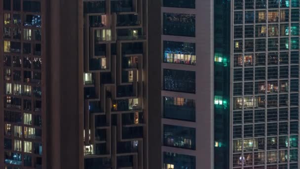 Windows in high-rise building exterior in the late evening with interior lights on timelapse — Stock Video