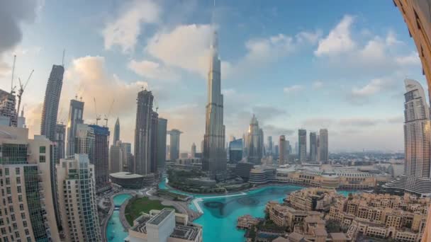 Arranha-céus subindo acima do Dubai no centro da cidade dia a noite timelapse cercado por edifícios modernos vista aérea superior — Vídeo de Stock