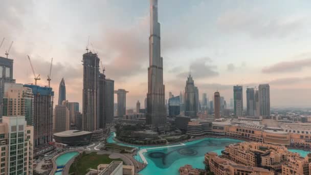 Небоскрёбы, возвышающиеся над центром Дубая изо дня в день, в окружении современных зданий с видом на вершину — стоковое видео