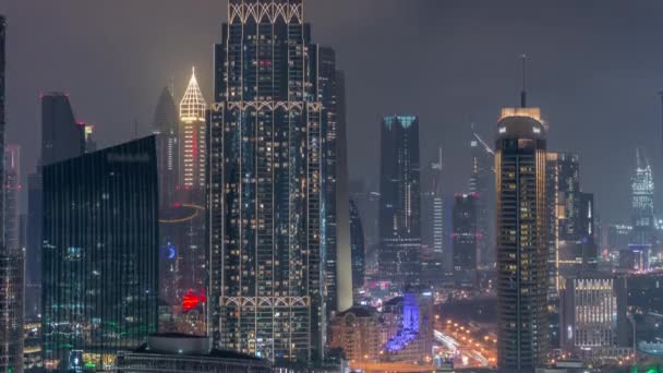 Widok z lotu ptaka na Dubai International Financial Centre DIFC district night timelapse — Wideo stockowe