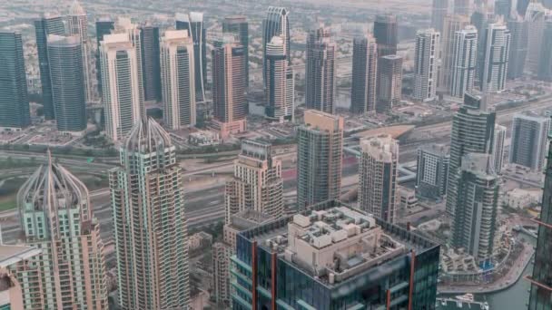 Небоскрёбы JLT и Dubai marina возле воздушного пространства Шейх Заид Роуд день и ночь. Жилые здания — стоковое видео