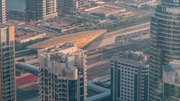 Futuristic buildings of Dubai with metro station and luxury skyscrapers behind near Dubai Marina timelapse — Stock Video