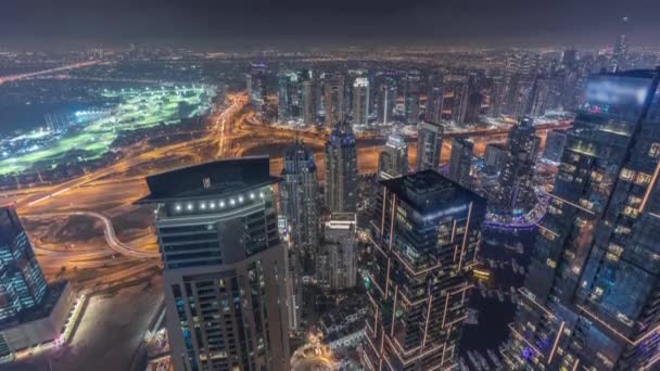 Panorama of Dubai Marina with JLT skyscrapers and golf course night timelapse, Dubai, United Arab Emirates. — Stock Video