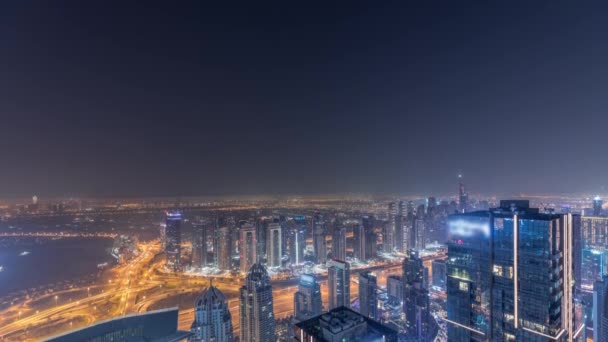 Panorama of Dubai Marina with JLT skyscrapers and golf course night to day timelapse, Dubai, United Arab Emirates. — Stock Video