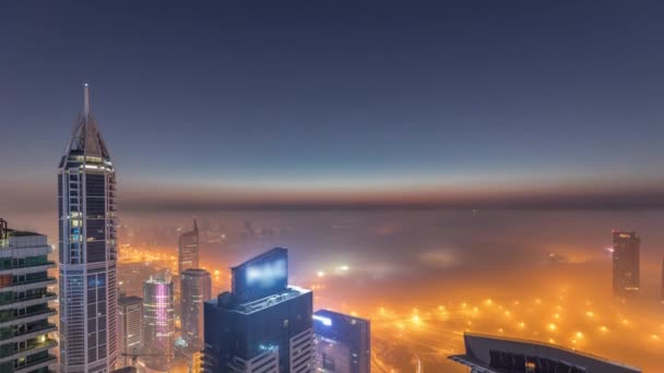 Nevoeiro de inverno raro no início da manhã acima do horizonte da Marina do Dubai e arranha-céus iluminados por luzes de rua noite aérea a dia timelapse. — Vídeo de Stock