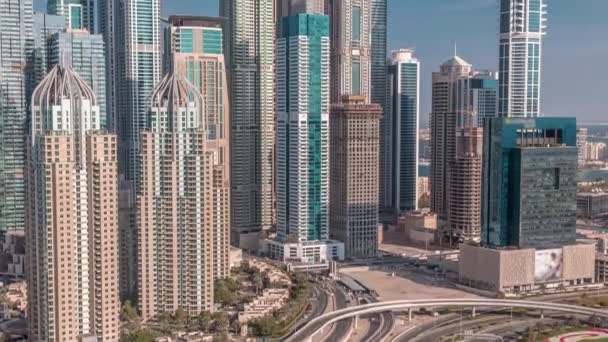 Skyscrapers of Dubai Marina near intersection on Sheikh Zayed Road with highest residential buildings timelapse — Stock Video