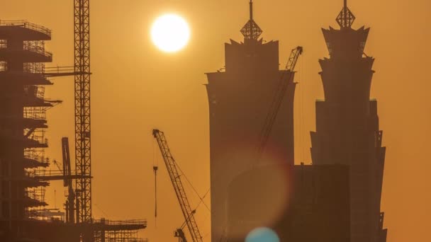 Dubais business bay towers at sunset aerial timelapse. Rooftop view of some skyscrapers — Stock Video