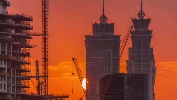 Dubais business bay towers at sunset aerial timelapse. Rooftop view of some skyscrapers — Stock Video