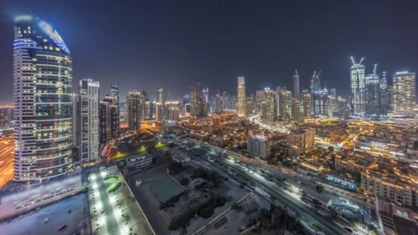 Dubais business bay towers aerial night timelapse. Rooftop view of some skyscrapers — Stock Video