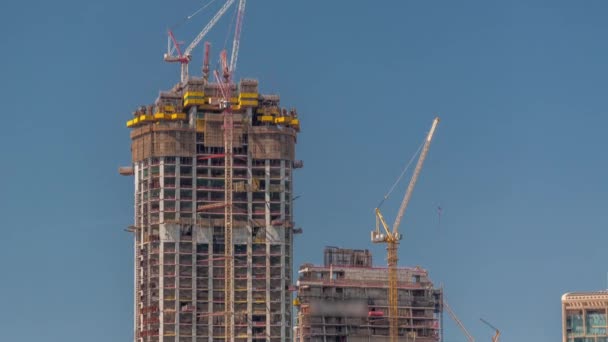 High multi-storey buildings under construction and cranes timelapse — Stock Video