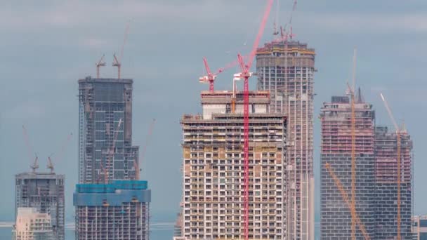 High multi-storey buildings under construction and cranes timelapse — Stock Video