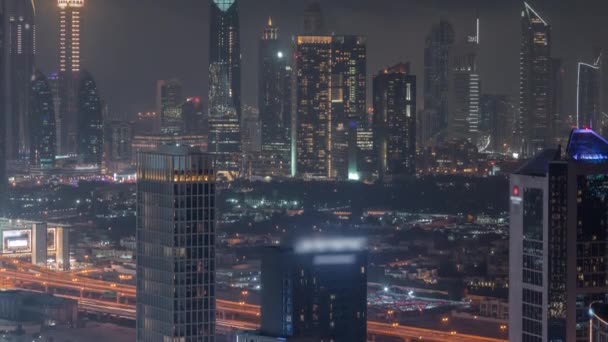 Filas de rascacielos en el distrito financiero de Dubai timelapse noche aérea. — Vídeos de Stock
