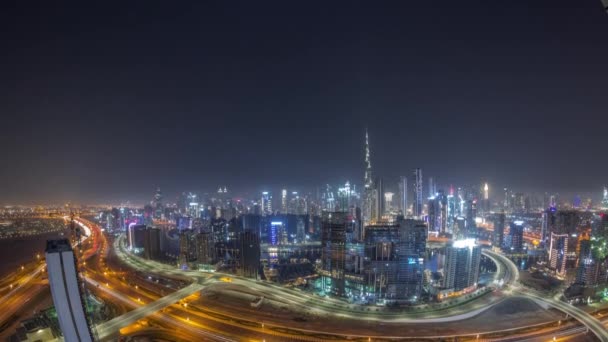 Panoramic skyline of Dubai with business bay and downtown district all night timelapse. — Stock Video