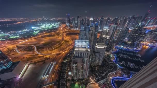 Dubai marina and JLT skyscrapers along Sheikh Zayed Road aerial night timelapse. — Stock Video