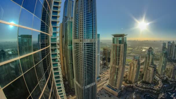 Modern skyscrapers in Dubai Marina with sun and reflection timelapse — Stock Video